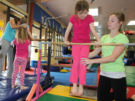 Practicing good form on the parallel bars